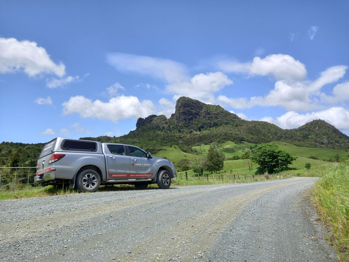 Lands and Survey ute on gravel road