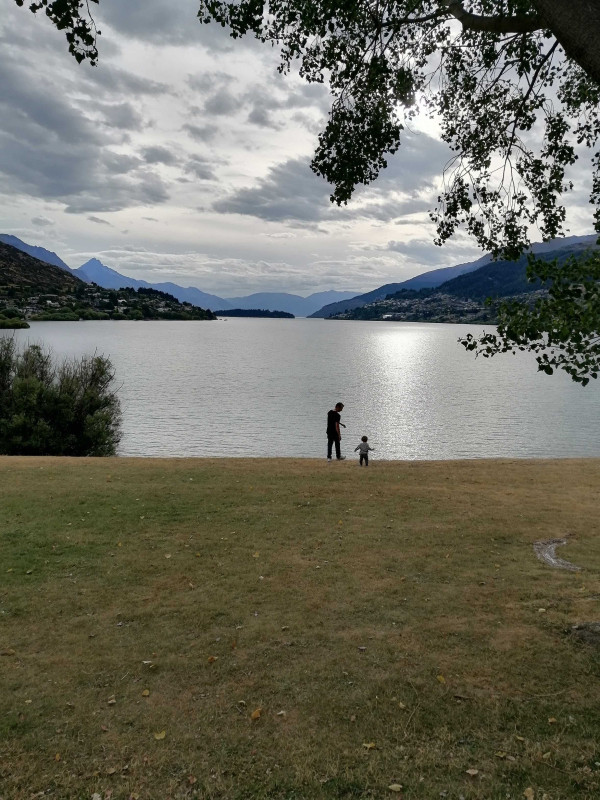 people standing in front of lake