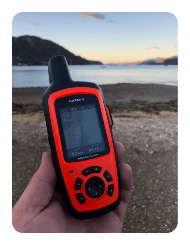 Garmin inReach Explorer+ satellite device displayed alongside a paired smartphone