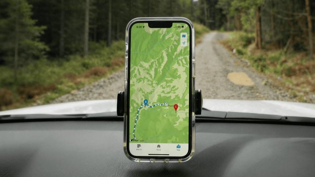 A phone on a car dashboard showing a map tracking location across a journey, using a direct-to-cell satellite connection.